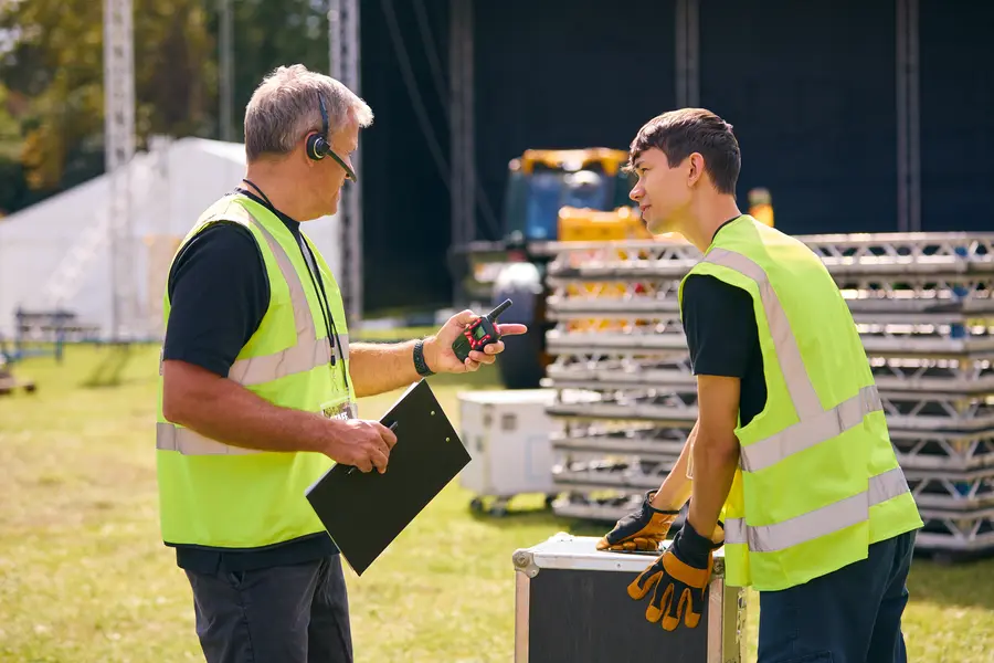 Two people setting up a summer festival