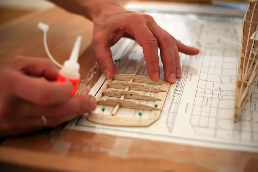 Detailed printed plans for a model airplane spread out for assembly